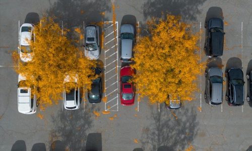 A parking lot filled with lots of parked cars
